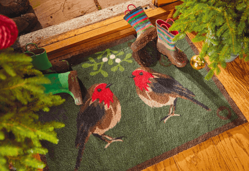 A Christmas front door mat with two robins on