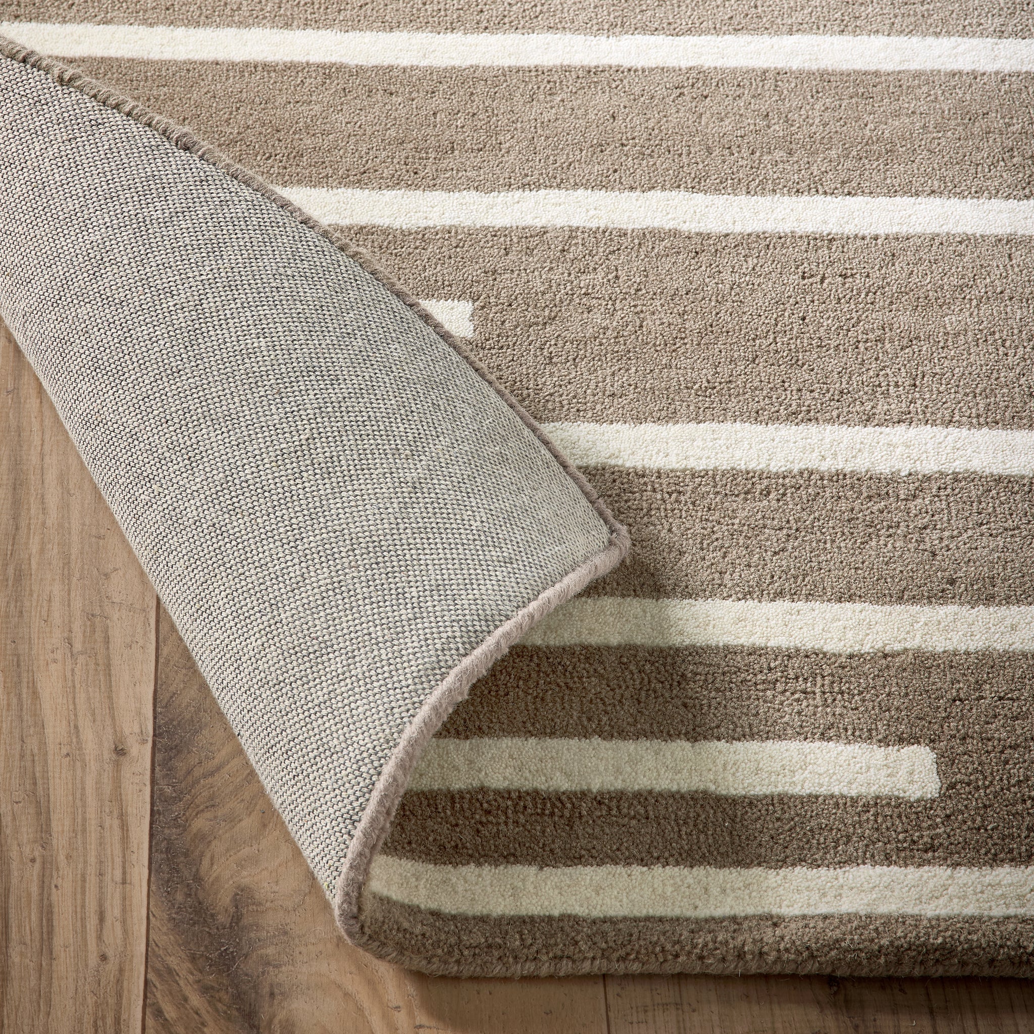 Broken Stripe- hand-tufted wool cut pile rug in Brown and White with a broken striped design.