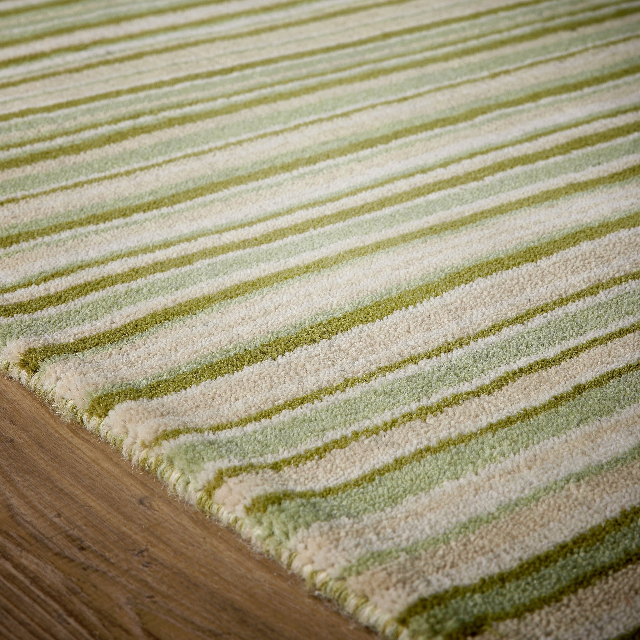 Green Fine Stripe Rug- 100% wool cut pile in green with a striped pattern.