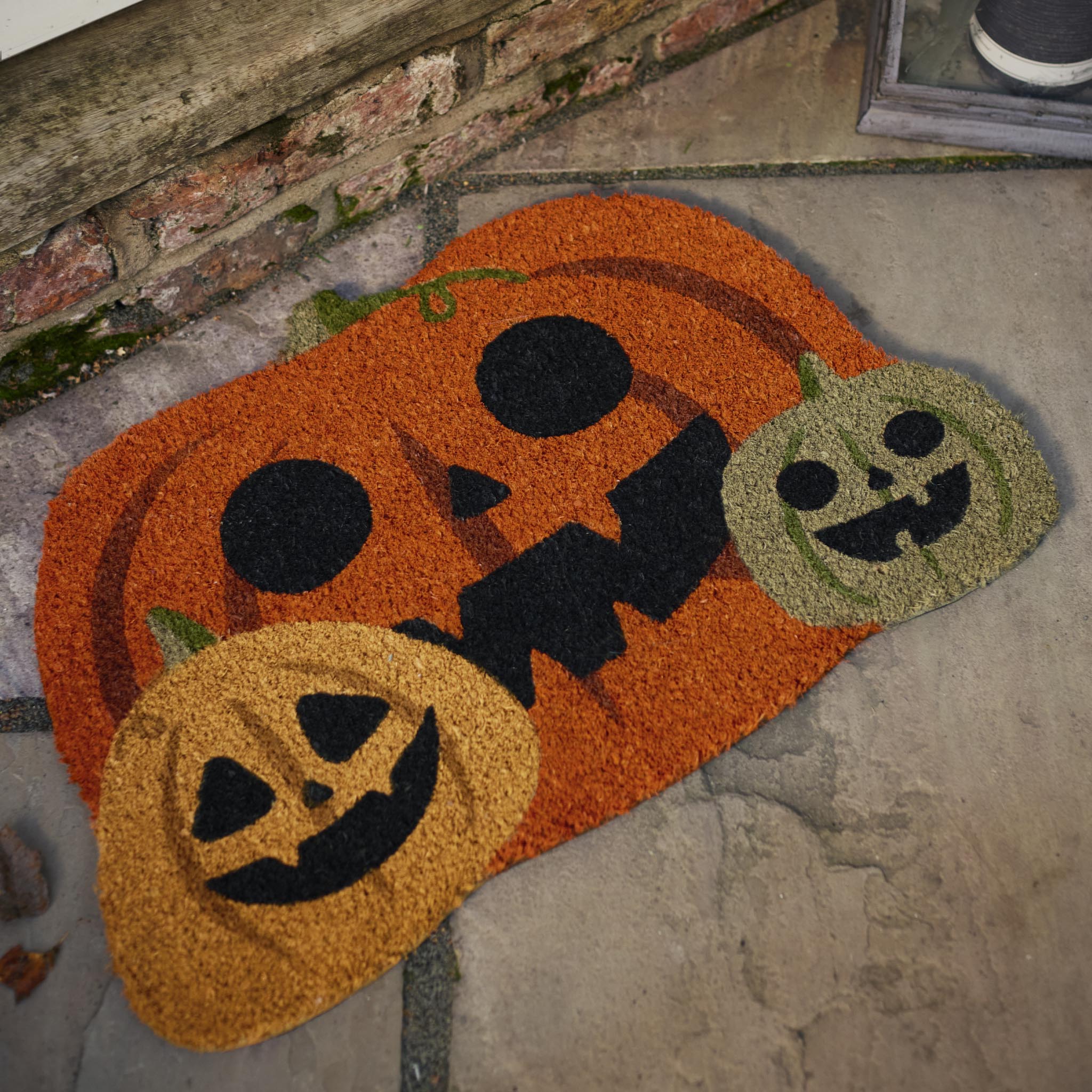 Discover the Pumpkin Halloween Coir Doormat in Orange- a coir mat with a graphic pumpkin design.