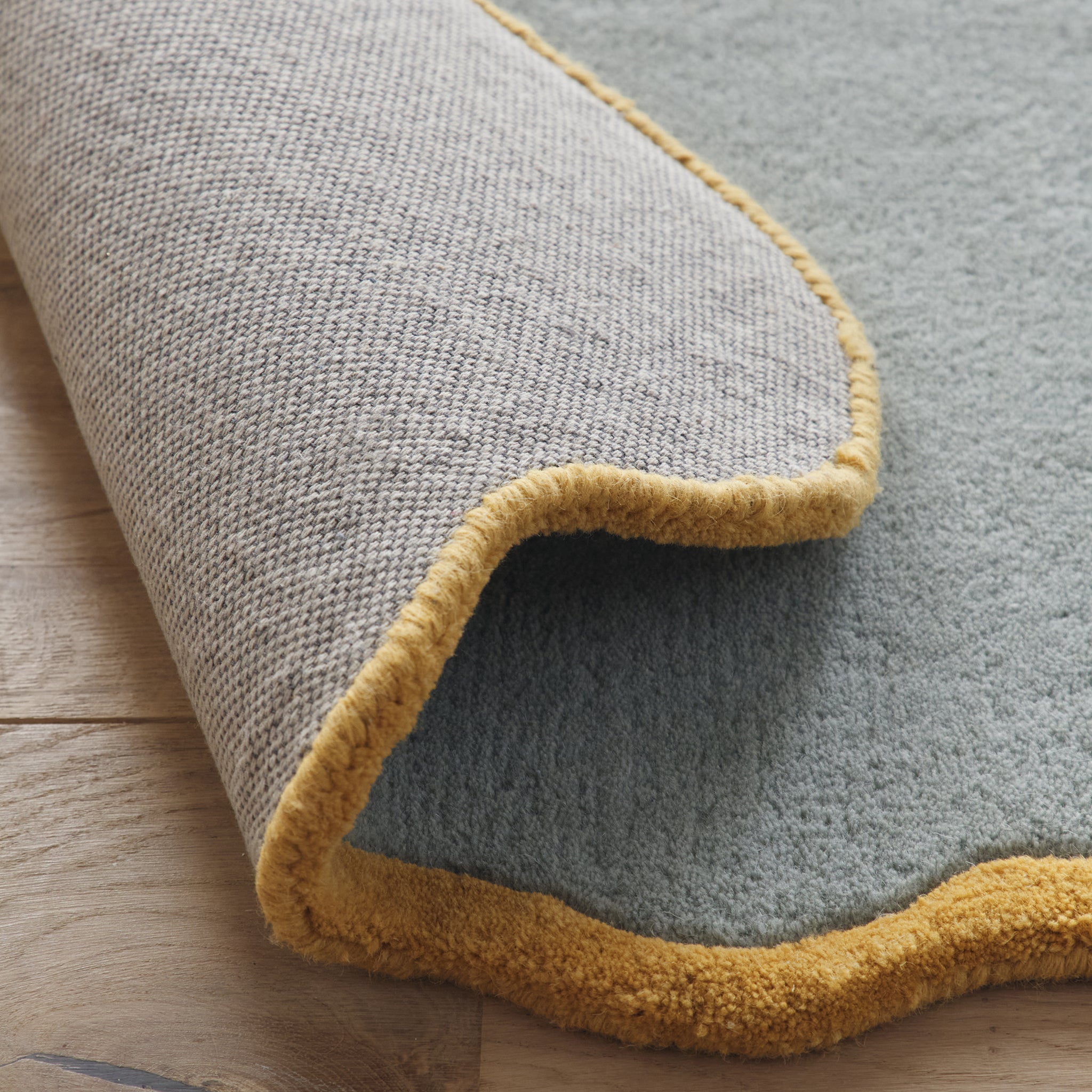 Scalloped Elsie Rug- a 100% hand-tufted rug in Duck Egg with wavy border.