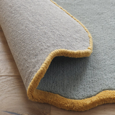 Scalloped Elsie Rug- a 100% hand-tufted rug in Duck Egg with wavy border.