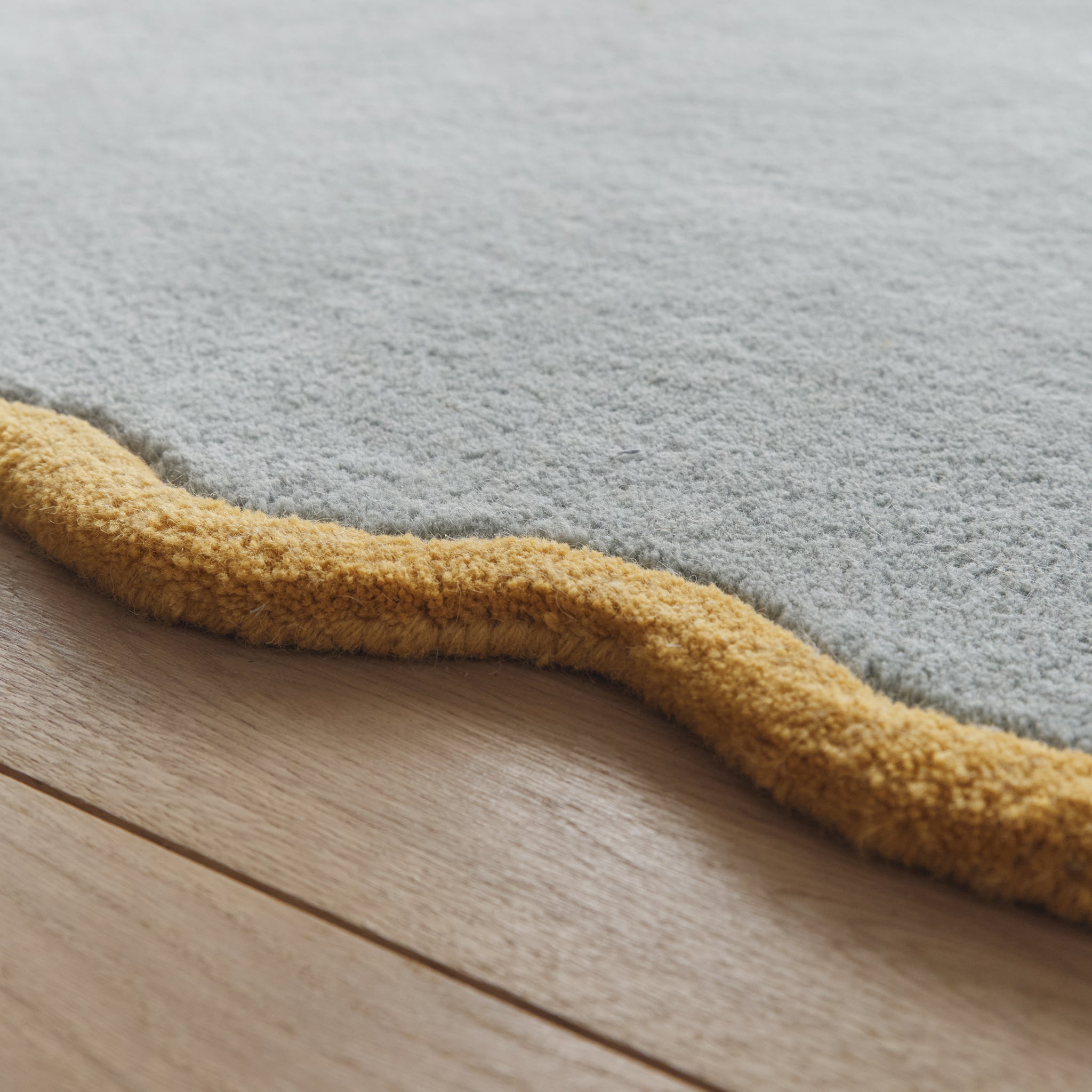 Scalloped Elsie Rug- a 100% hand-tufted rug in Duck Egg with wavy border.