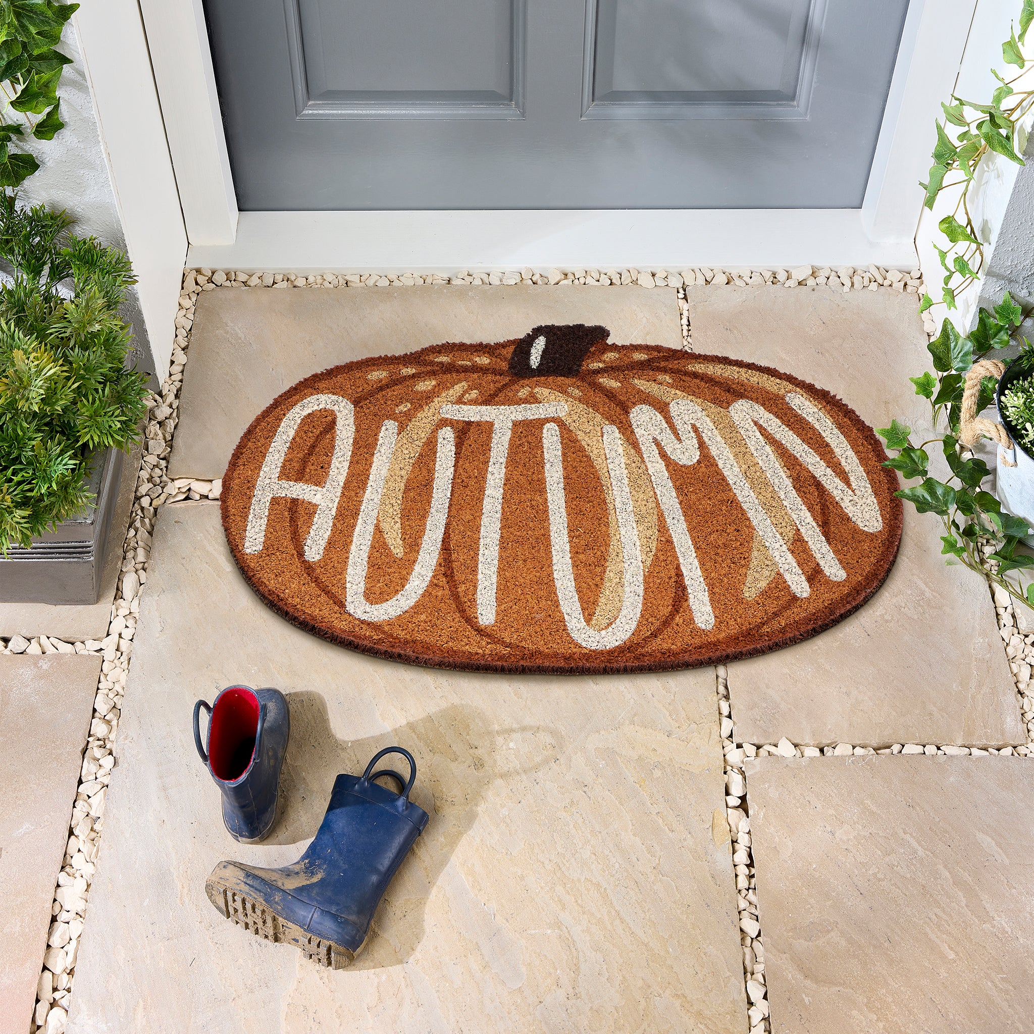 Discover the Shaped Autumn Pumpkin Coir Doormat- a coir dormant shaped as a pumpkin with graphic font.