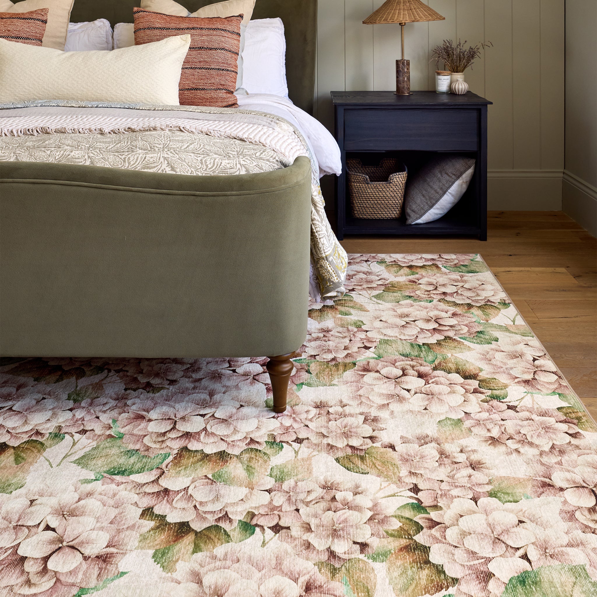 Floral rug with a hydrangea print design on styled in a bedroom