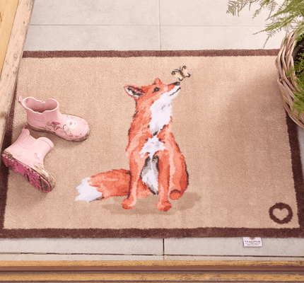 a ginger fox washable doormat at a front door