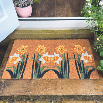 A coir doormat with a daffodil print design