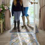 Daisy pattern on washable doormat in doorway