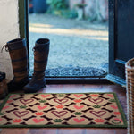 Lifestyle image of Hug Rug beige hearts and bones indoor washable doormat at front door
