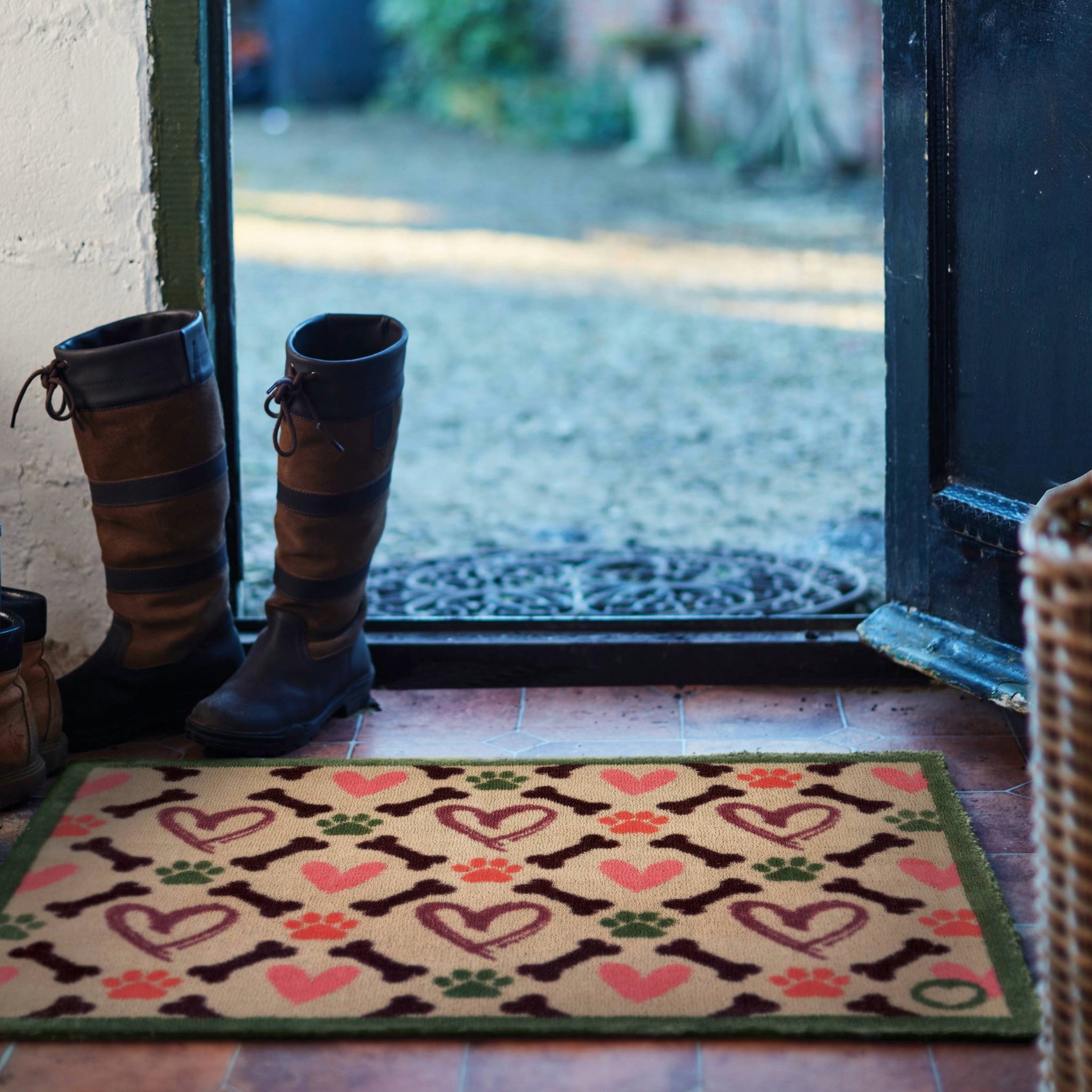 Lifestyle image of Hug Rug beige hearts and bones indoor washable doormat at front door