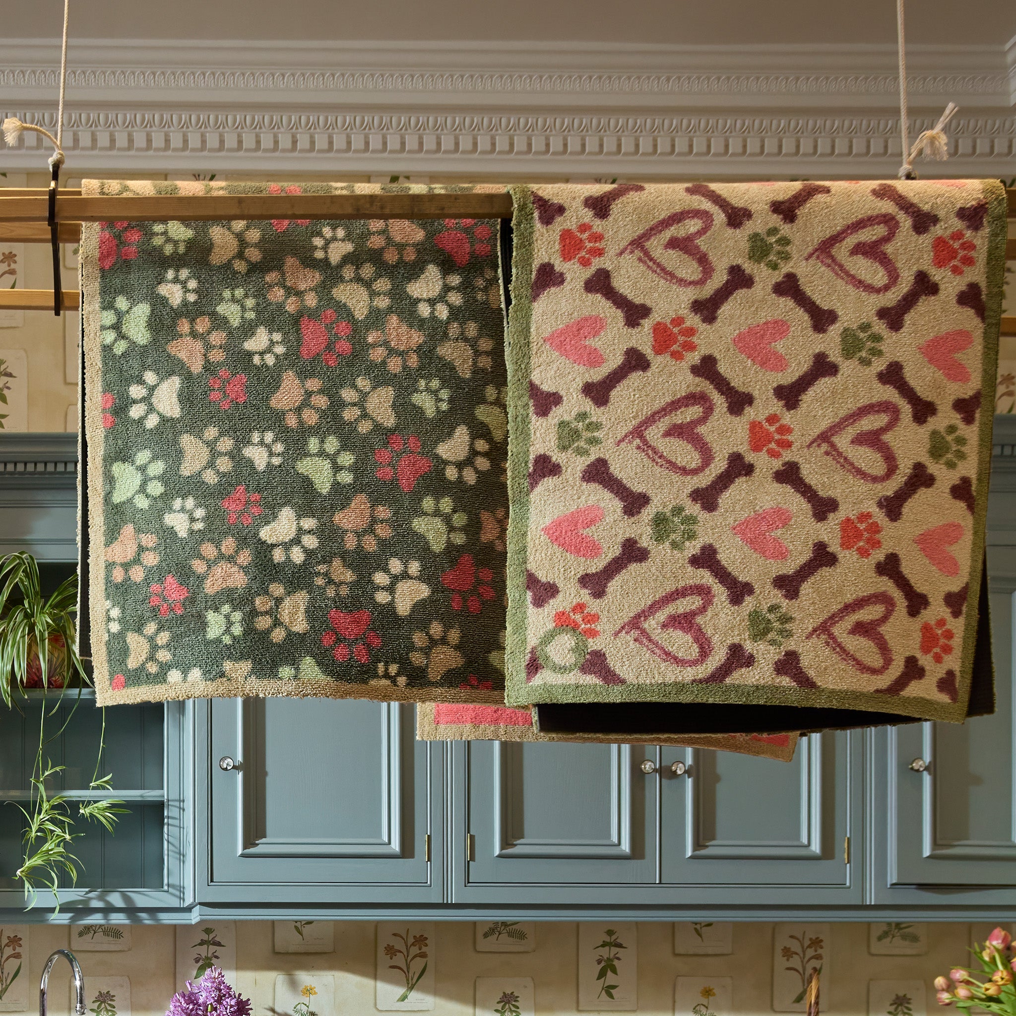 Lifestyle image of two Hug Rug indoor washable doormats hung to dry