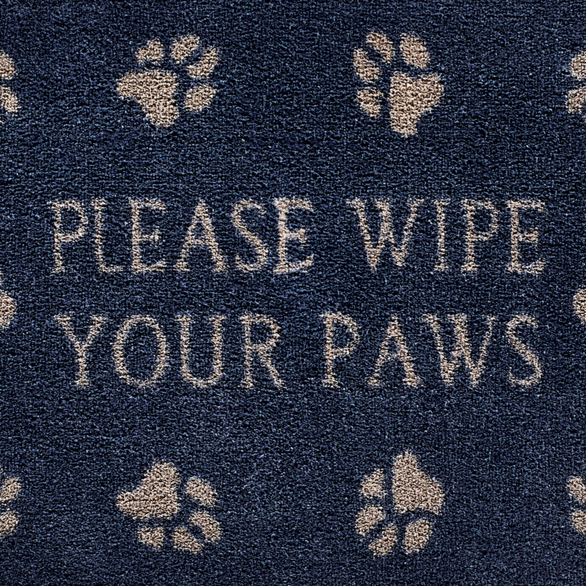 Close up image of the please wipe your paws text and pattern on a navy Pet 10 washable doormat from Hug Rug