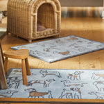 Lifestyle image of a blue Pet 75 washable doormat and washable runner from Hug Rug in living room