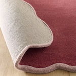 Scalloped Elise- 100% wool cut & loop pile rug in Coral and Lilac with a thick border. 