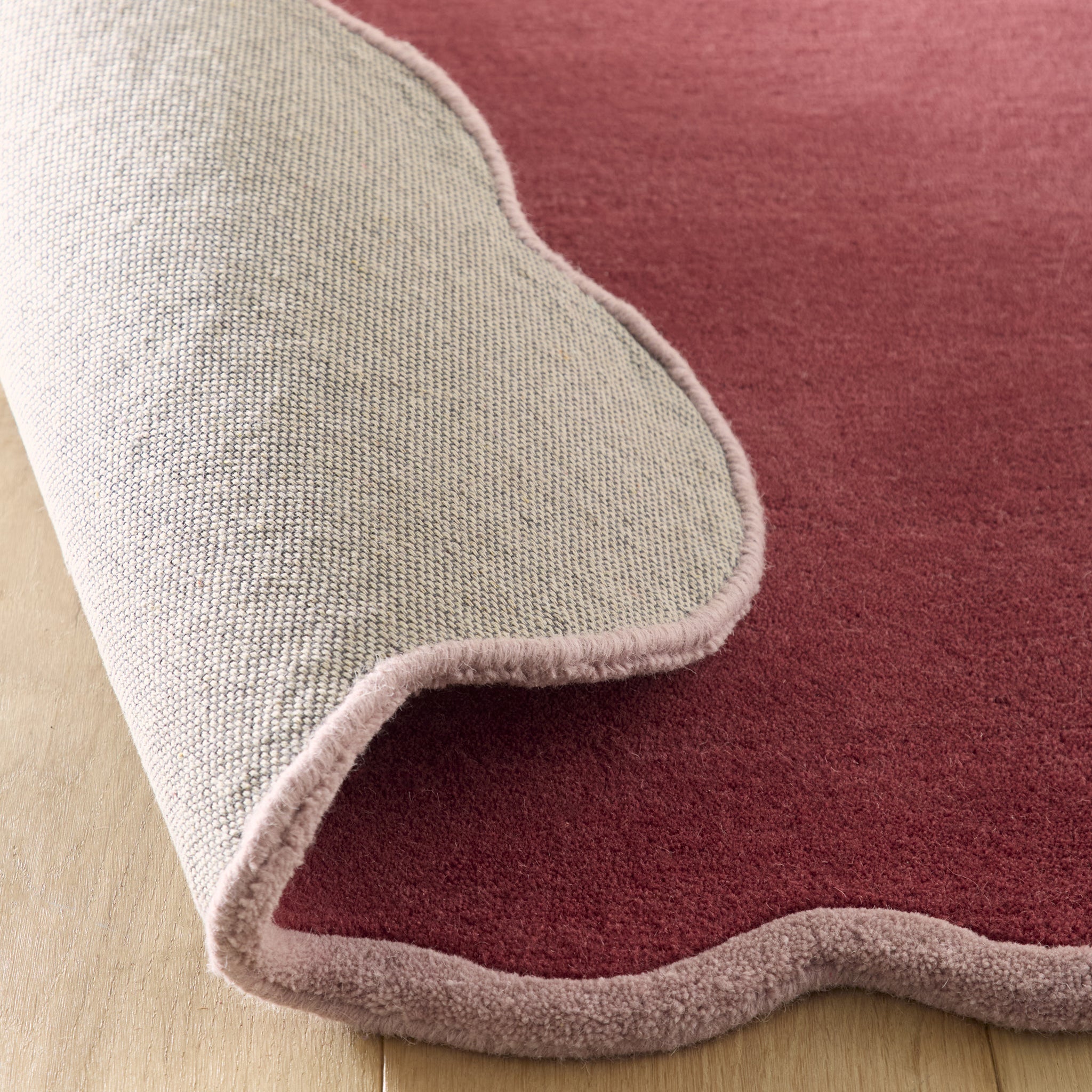 Scalloped Elise- 100% wool cut & loop pile rug in Coral and Lilac with a thick border. 