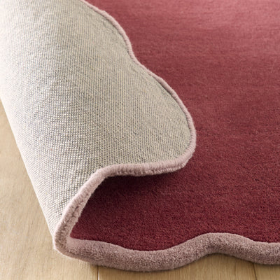 Scalloped Elise- 100% wool cut & loop pile rug in Coral and Lilac with a thick border. 