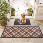 Lifestyle image of a dog sat on Hug Rug black tartan paw washable  doormat and matching washable runner