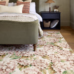 Floral rug with a hydrangea print design on styled in a bedroom