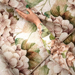 Hand holding a floral-patterned rug with a close-up of the pattern