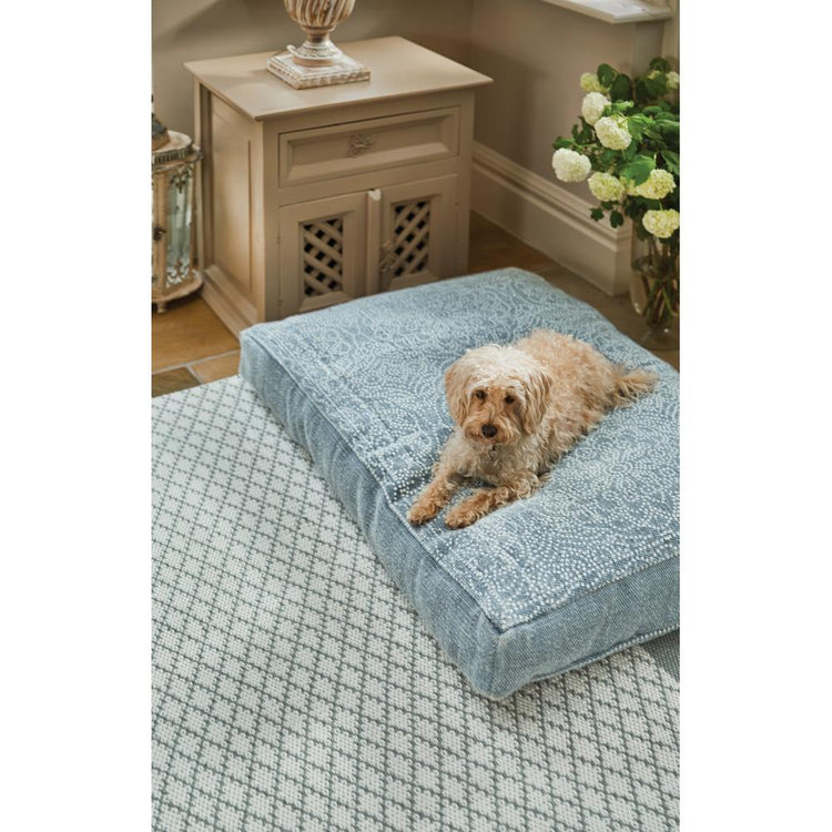 Dog laid on blue denim pet bed